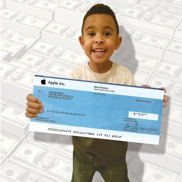 young boy holding dividend check